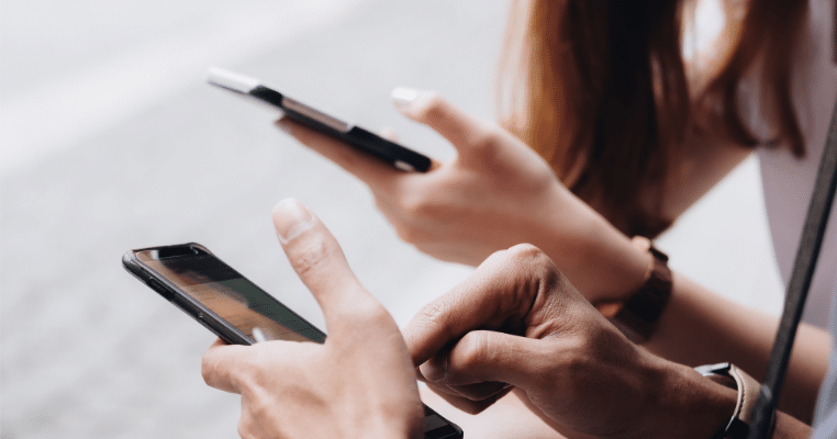 2 hands holding phones