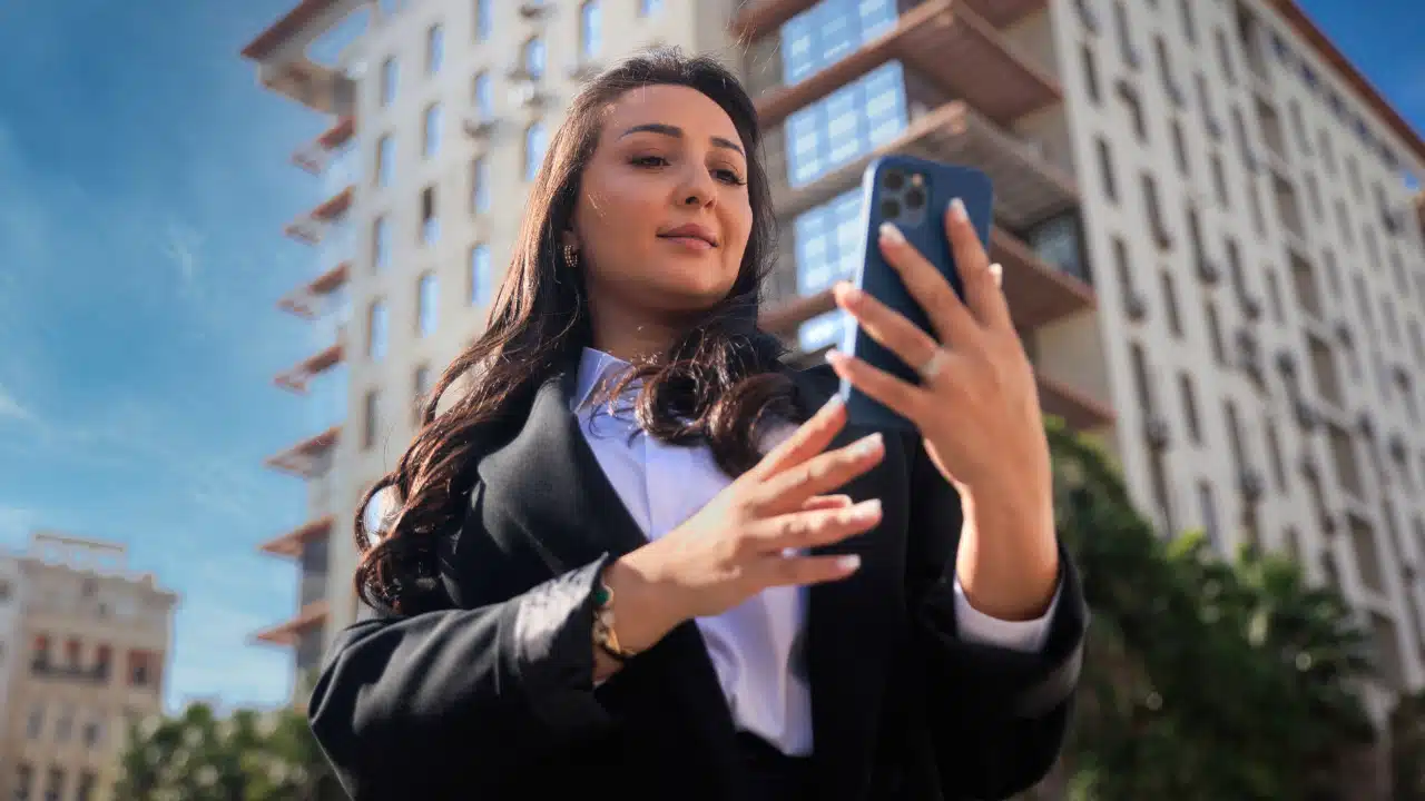 women holding a phone with her two hands