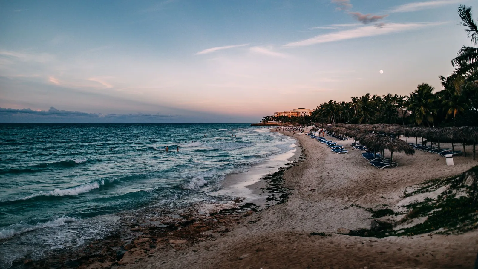 Varadero beach in Cuba at sunset, palm trees and turquoise sea