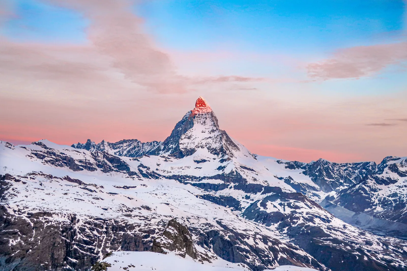 The peak of the Matterhorn lit by sunrise above Zermatt in the Swiss Alps