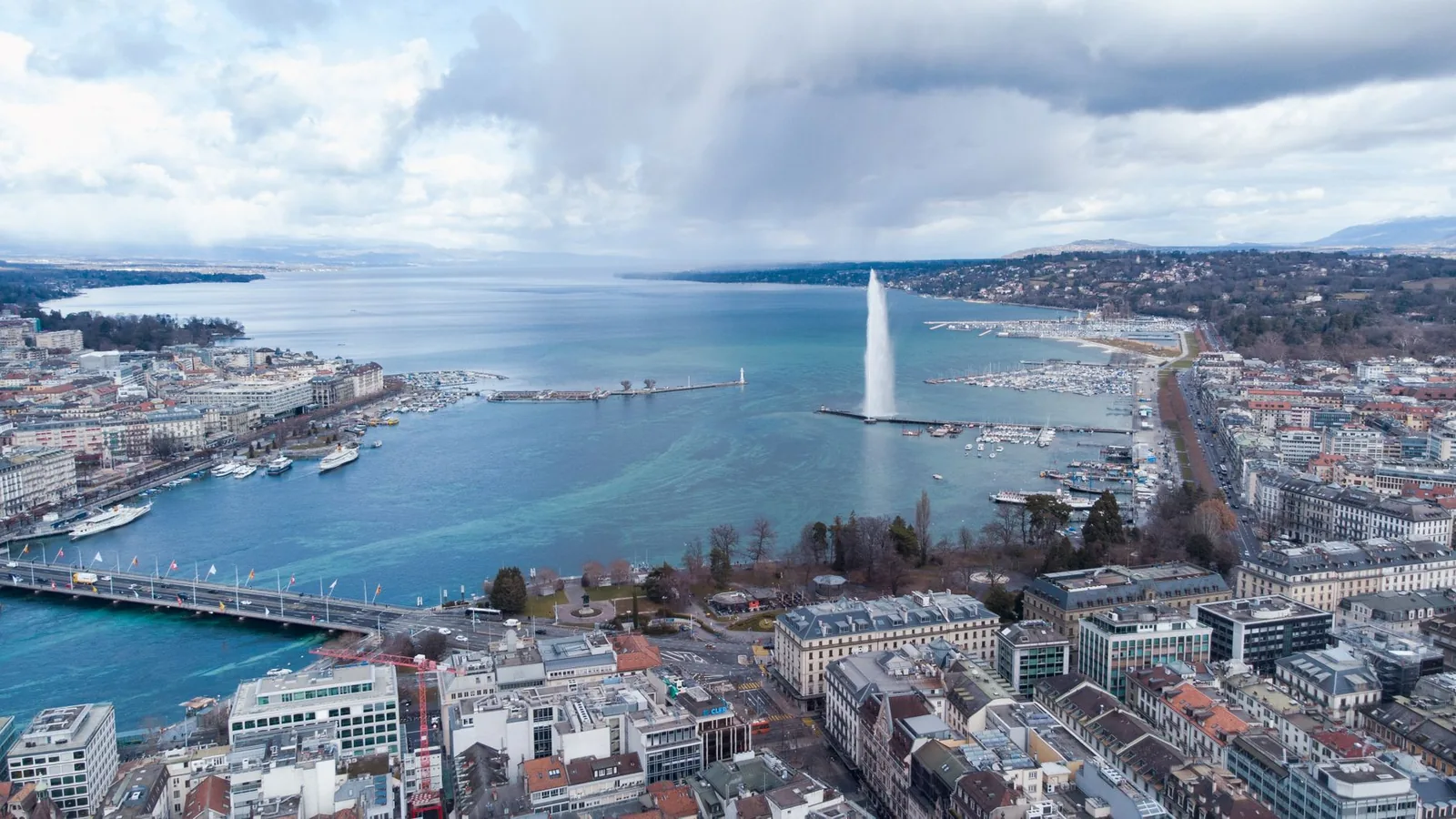 Aerial view of Geneva with the Jet d'Eau over Lake Geneva, the harbour and the city, Switzerland