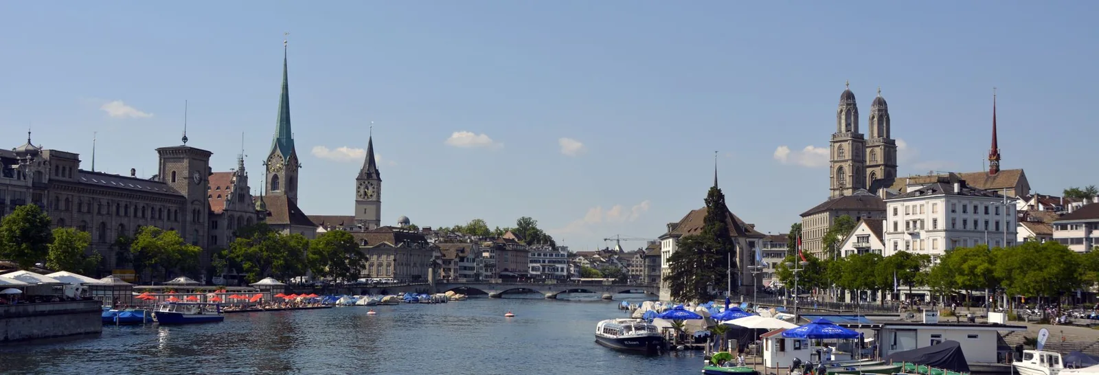 Panorama of Zurich along the Limmat river with the Grossmunster towers and the Fraumunster spire, Switzerland