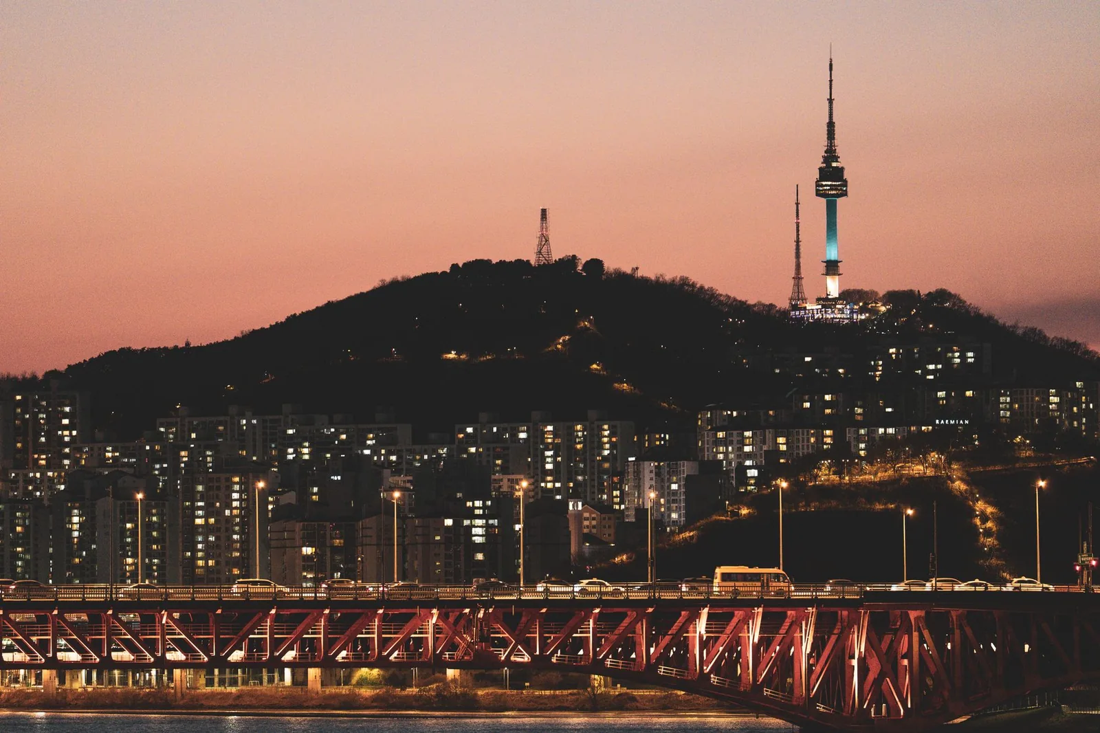Namsan N Seoul Tower lit up at nightfall, overlooking the Han River and the lights of Seoul